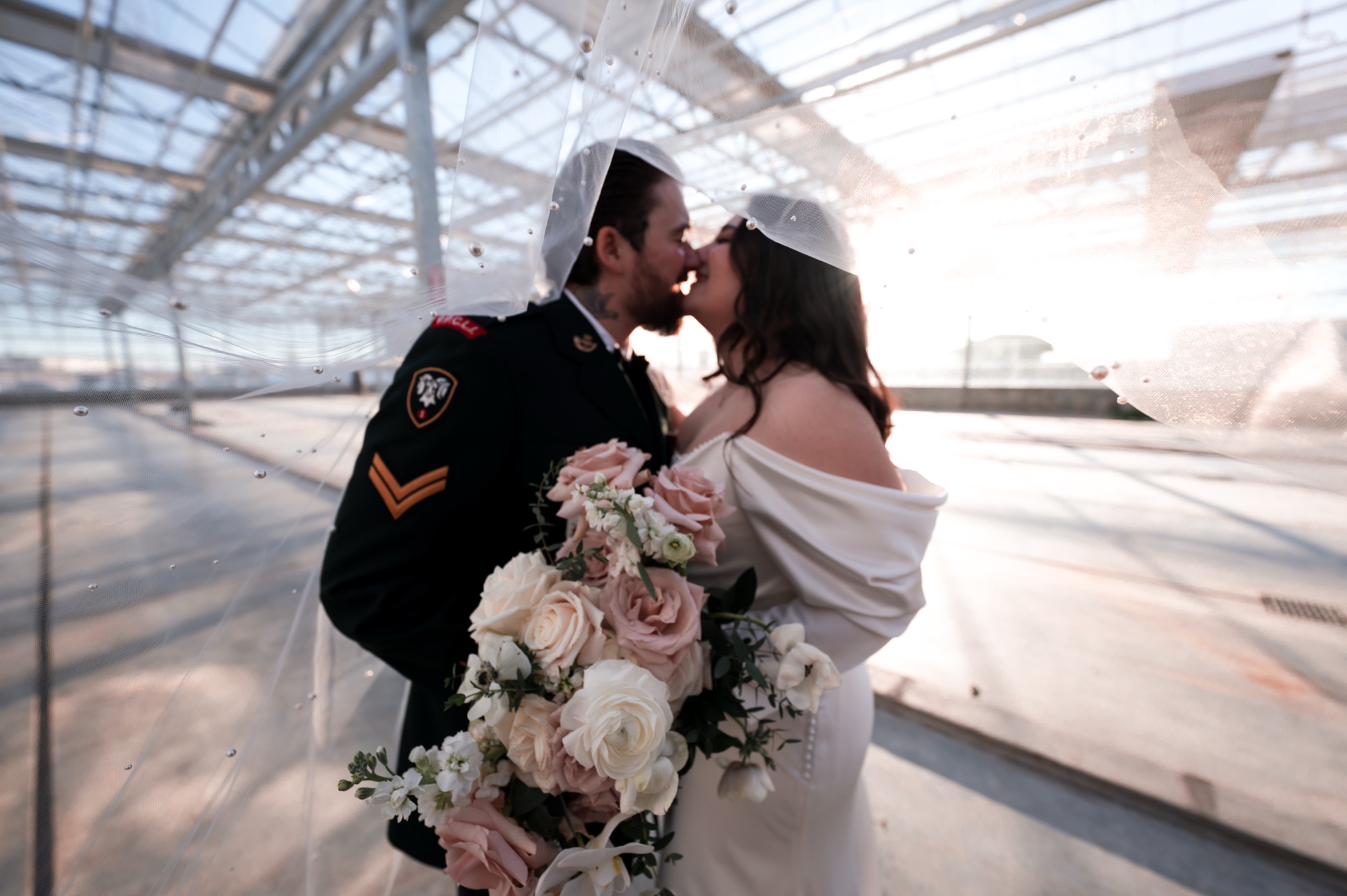Bride and groom kiss under the veil at romantic wedding in the Moonflower room at the St. Albert Enjoy Centre